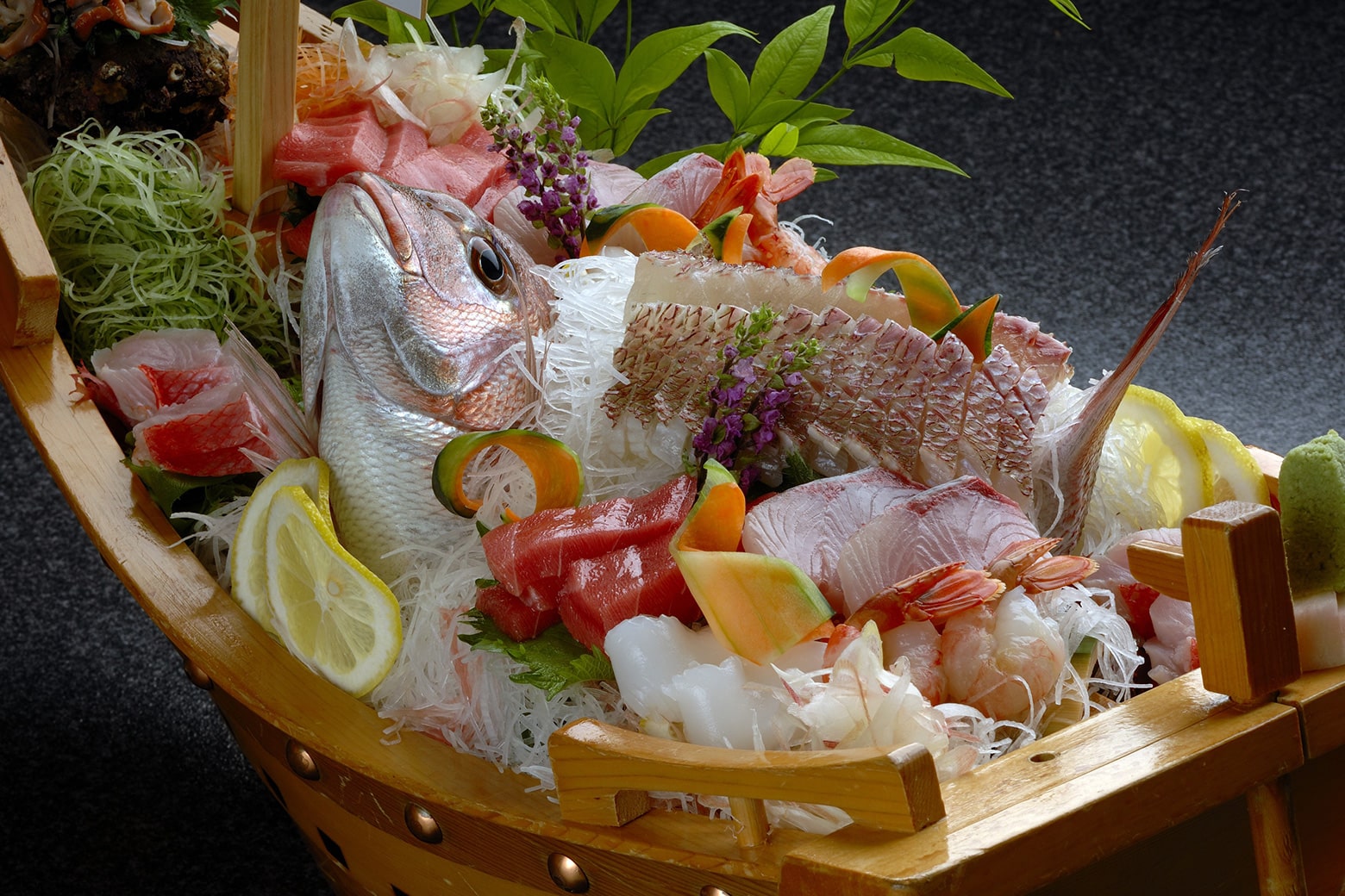 Assorted sashimi served on a ship-shaped platter